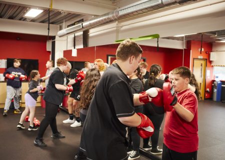 Young people boxing at a CEW clinic