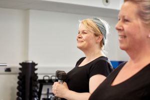 two women with dumbells